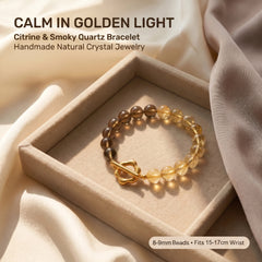 Golden citrine and smoky quartz crystal bracelet with gold clasp on soft neutral fabric background