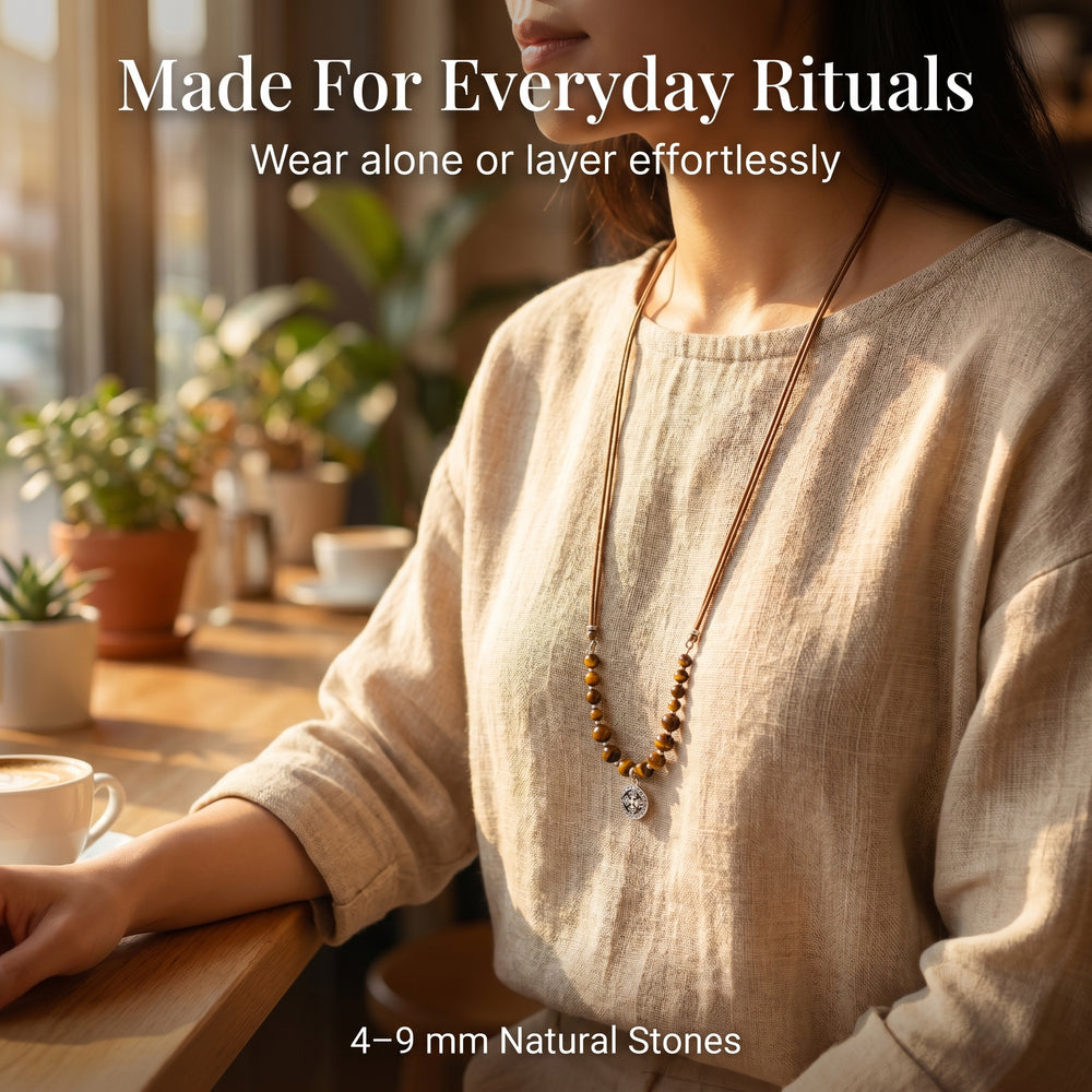 Woman wearing long Tiger Eye crystal necklace in neutral linen outfit