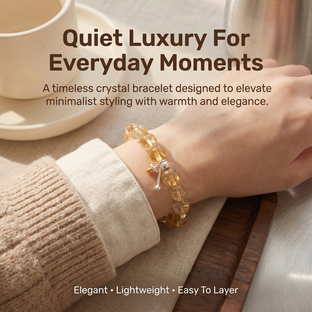 Elegant lifestyle image of woman wearing yellow phantom quartz bracelet with neutral fashion styling