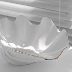 Minimalist white shell craft product bowl with delicate gold trim, stylish decorative tray for rings, earrings, or small items.