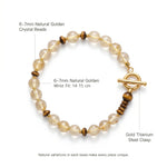 Healing golden crystal bracelet with gold titanium steel clasp, flat lay on white background showing 6-7mm natural beads and 14-15 cm wrist fit.