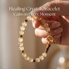 Close-up of a woman wearing the healing golden crystal bracelet on her left wrist, natural beads glowing softly, everyday calm accessory with secure gold clasp.
