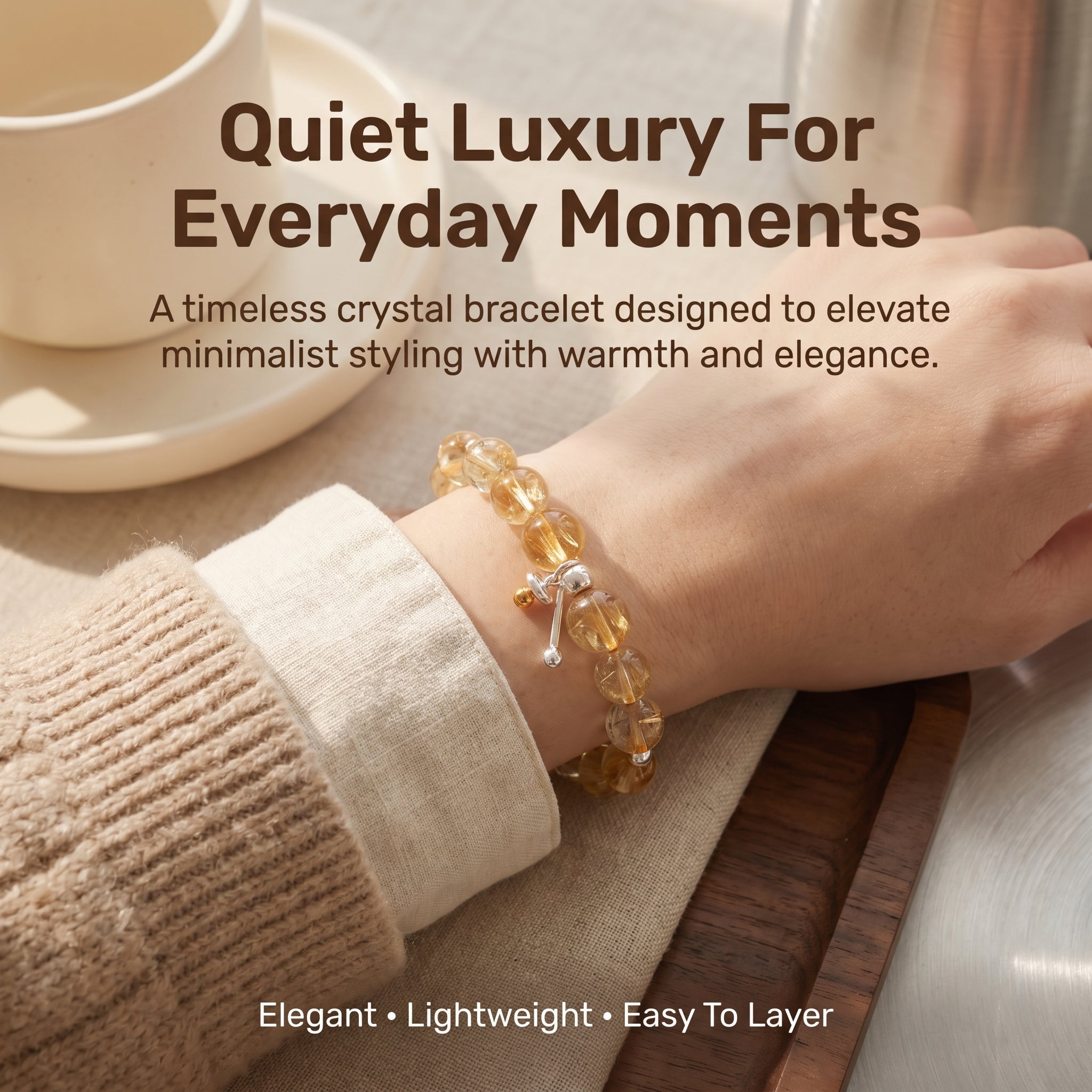 Elegant lifestyle image of woman wearing yellow phantom quartz bracelet with neutral fashion styling